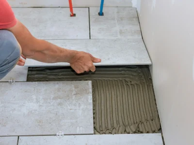 home-construction-working-with-placing-ceramic-floor-tiles-on-adhesive